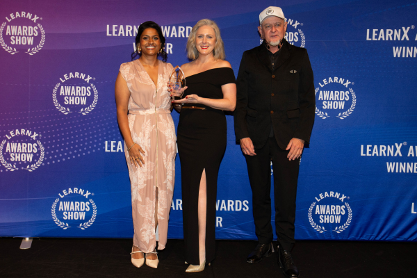 Image caption: Sirini Griffiths and Ellen Valvasori receiving the award, with Alexander Roche from Androgogic